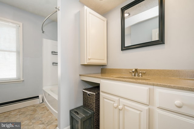 bathroom with tub / shower combination, a baseboard radiator, and vanity