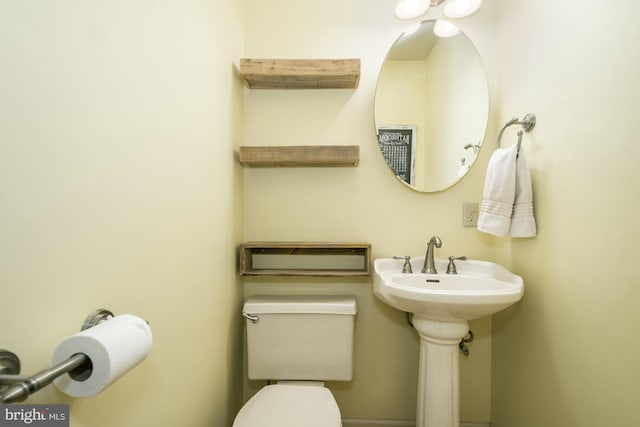 half bathroom with toilet and a sink