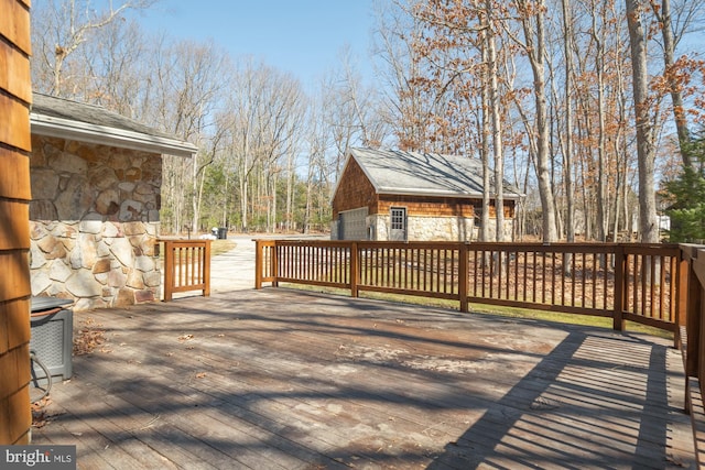 wooden terrace featuring an outdoor structure