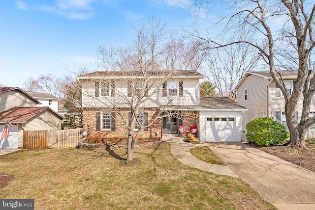 colonial-style house with fence, driveway, an attached garage, a front lawn, and brick siding