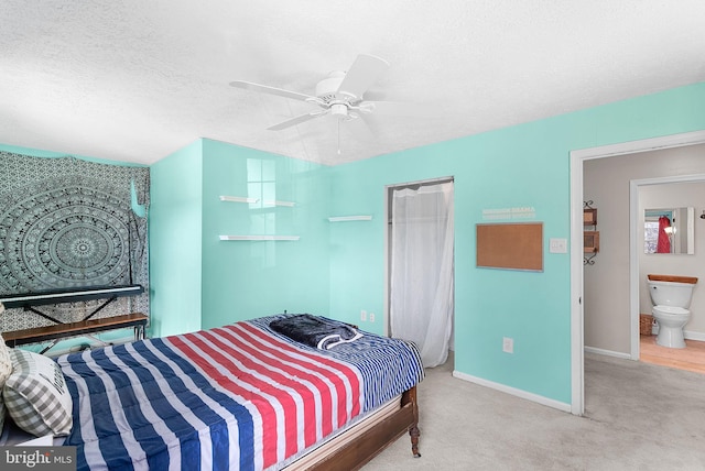 bedroom featuring a ceiling fan, baseboards, a closet, a textured ceiling, and carpet flooring