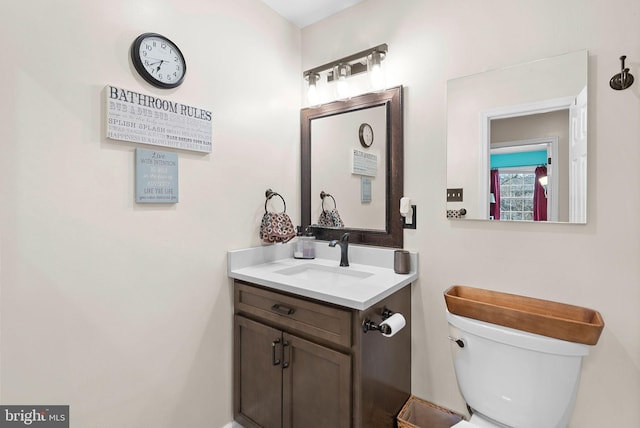 bathroom featuring toilet and vanity