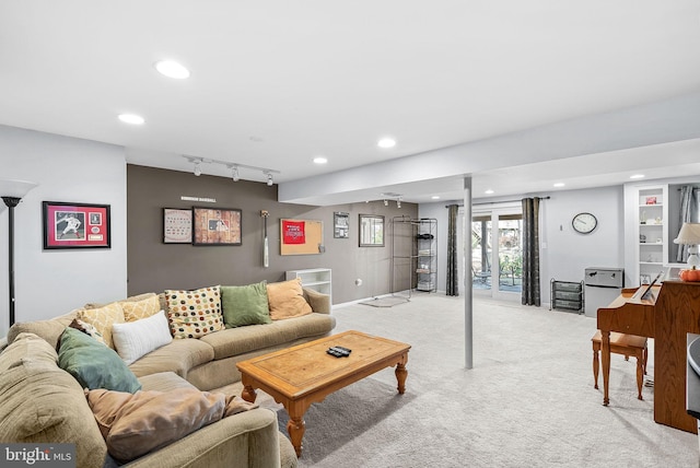 living area featuring rail lighting, recessed lighting, and light colored carpet