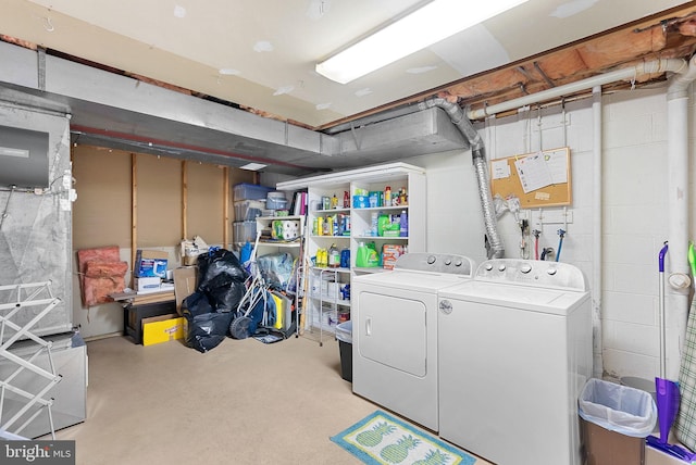 laundry room with laundry area, concrete block wall, and independent washer and dryer