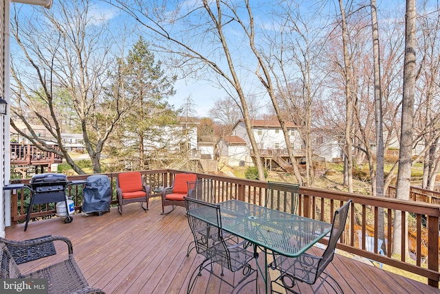 deck featuring area for grilling and outdoor dining space