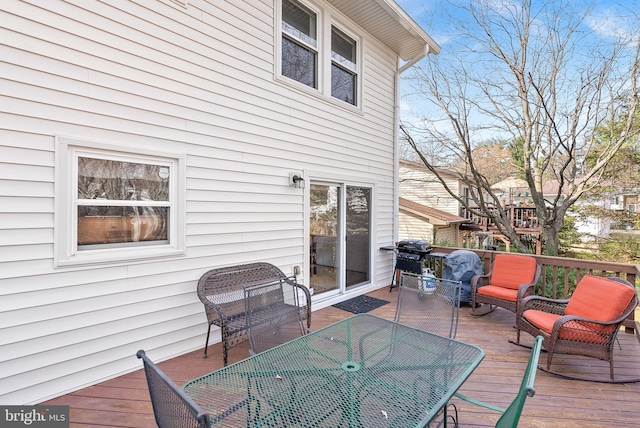 wooden terrace featuring grilling area