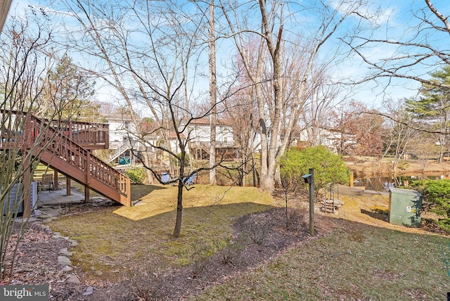 view of yard featuring stairway and a wooden deck