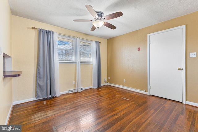 spare room with visible vents, a textured ceiling, and hardwood / wood-style floors