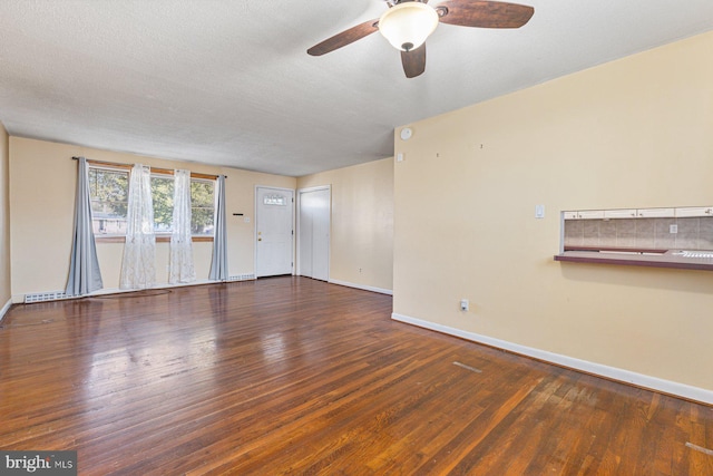 spare room featuring baseboards, a textured ceiling, wood finished floors, and a ceiling fan