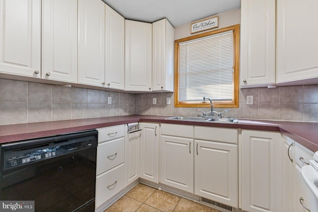 kitchen featuring a sink, tasteful backsplash, dishwasher, and white cabinetry