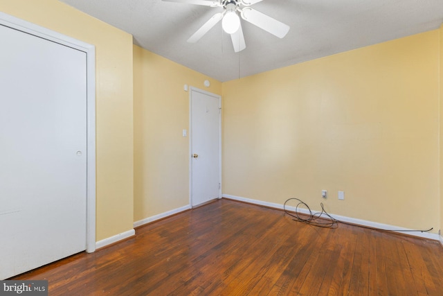 unfurnished room featuring a ceiling fan, baseboards, and hardwood / wood-style floors