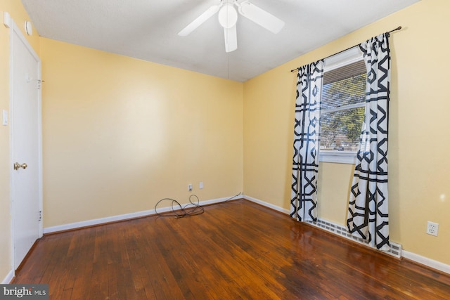 empty room featuring a ceiling fan, baseboards, and hardwood / wood-style floors