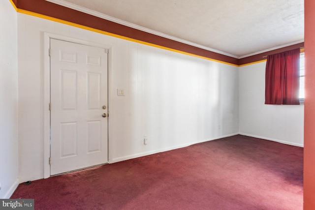 carpeted empty room featuring baseboards