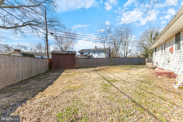 view of yard with an outbuilding and a fenced backyard