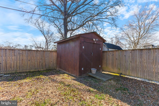 view of shed with a fenced backyard