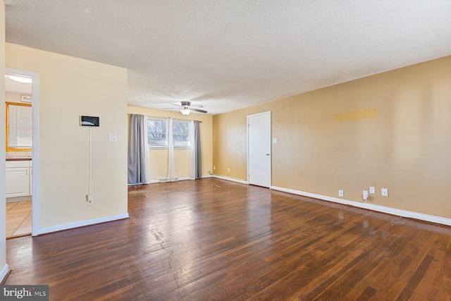 empty room featuring baseboards, a textured ceiling, ceiling fan, and hardwood / wood-style flooring