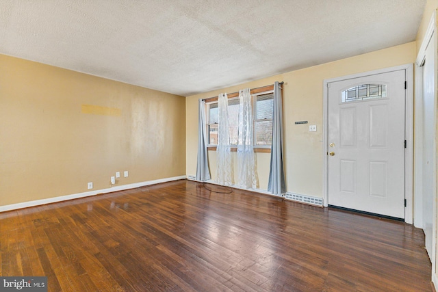 foyer featuring a textured ceiling and hardwood / wood-style floors