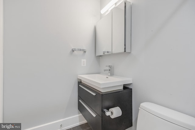 bathroom featuring toilet and vanity