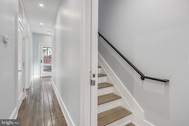 stairs with recessed lighting, baseboards, and wood finished floors