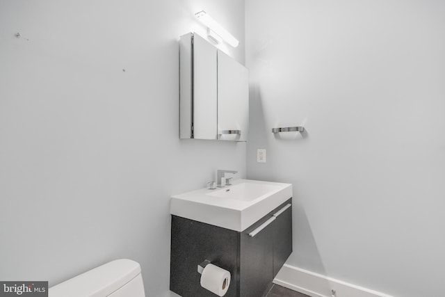 bathroom with toilet and vanity