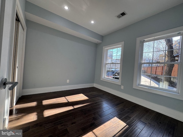 unfurnished room featuring recessed lighting, visible vents, baseboards, and dark wood-type flooring