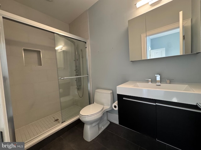 full bathroom featuring tile patterned floors, toilet, a stall shower, and vanity