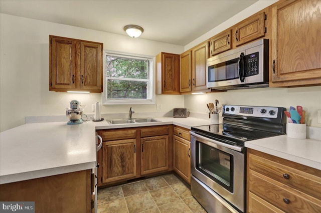 5 Westpointe Dr, Ephrata, PA 17522 - kitchen with appliances with stainless steel finishes, a sink, brown cabinets, and light countertops