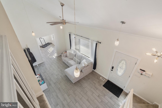 unfurnished living room featuring baseboards, high vaulted ceiling, and a ceiling fan