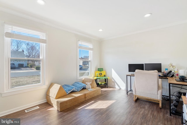 office with baseboards, wood finished floors, visible vents, and ornamental molding