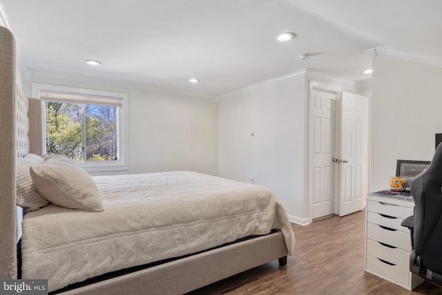 bedroom featuring recessed lighting, wood finished floors, baseboards, and ornamental molding