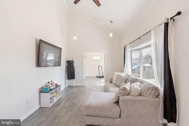 living room featuring wood finish floors, baseboards, and crown molding