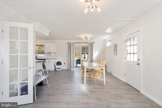 dining room featuring electric panel, plenty of natural light, crown molding, and baseboards