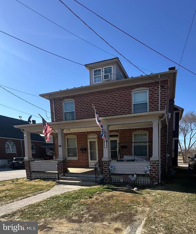 traditional style home with brick siding and covered porch