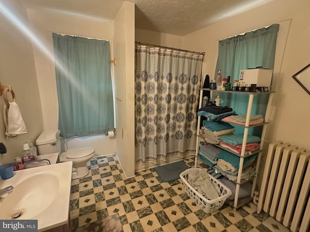 full bathroom with tile patterned floors, a shower with curtain, radiator, and toilet