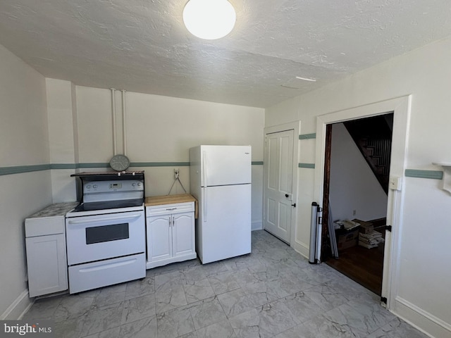 kitchen featuring marble finish floor, white appliances, and light countertops