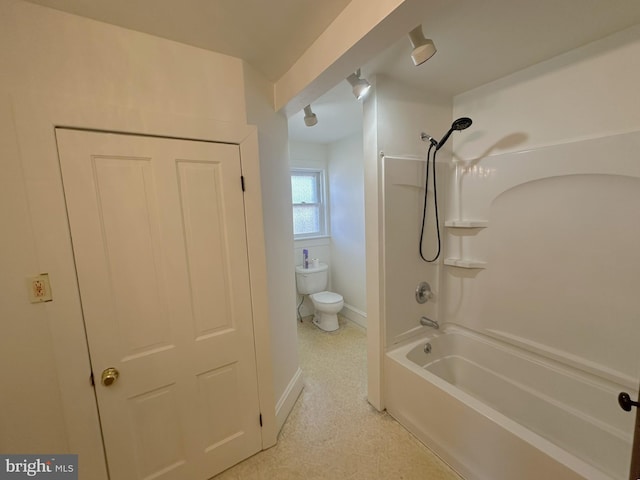 full bathroom featuring toilet, baseboards, and shower / washtub combination