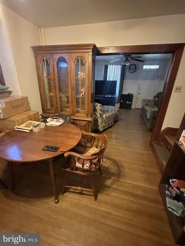 dining area with wood finished floors and ceiling fan