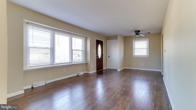 entrance foyer with a ceiling fan, wood finished floors, baseboards, and visible vents