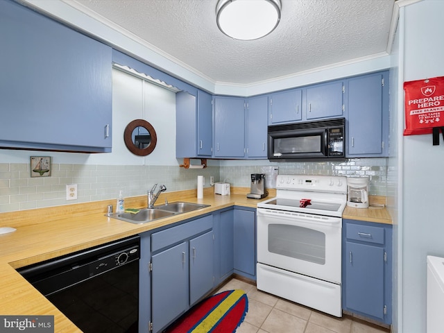 kitchen featuring black appliances, a sink, blue cabinetry, tasteful backsplash, and light countertops