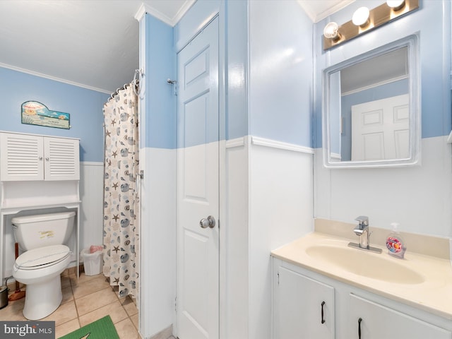 bathroom with tile patterned flooring, crown molding, toilet, and a wainscoted wall