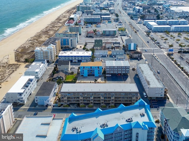 drone / aerial view with a view of city, a view of the beach, and a water view