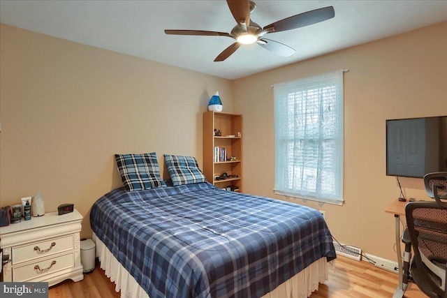 bedroom featuring wood finished floors and ceiling fan