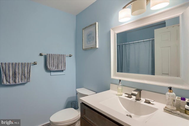 full bathroom with toilet and vanity