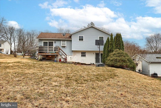 rear view of house with a deck, stairway, and a yard