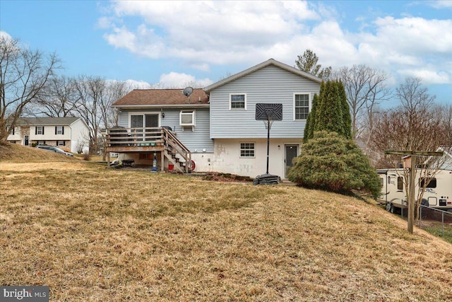 back of property with a yard and a wooden deck