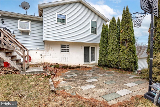 back of house featuring stairs and a patio area