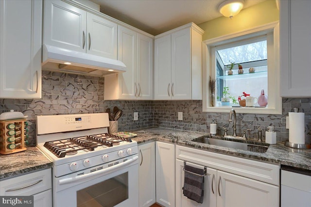 kitchen with gas range gas stove, under cabinet range hood, decorative backsplash, white cabinetry, and a sink