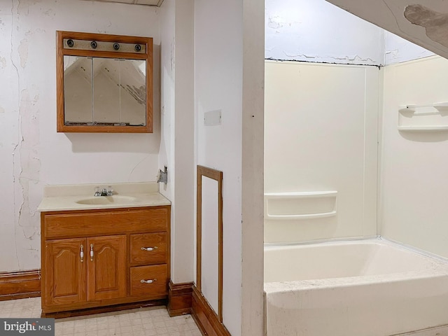 bathroom featuring tile patterned floors, a tub to relax in, and vanity