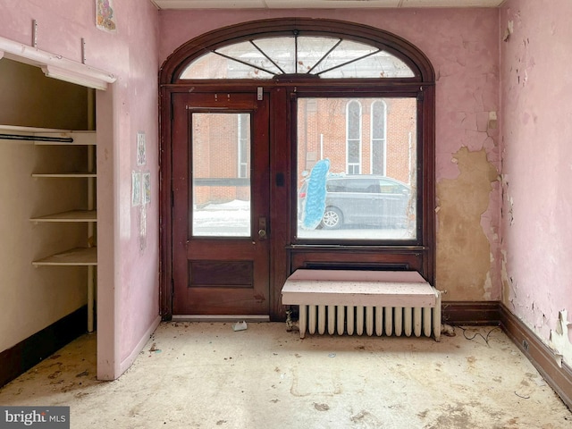 foyer entrance with french doors and baseboards