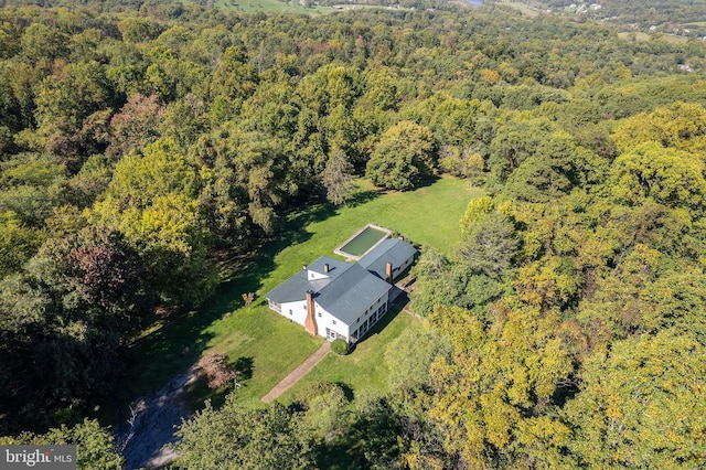 drone / aerial view featuring a forest view